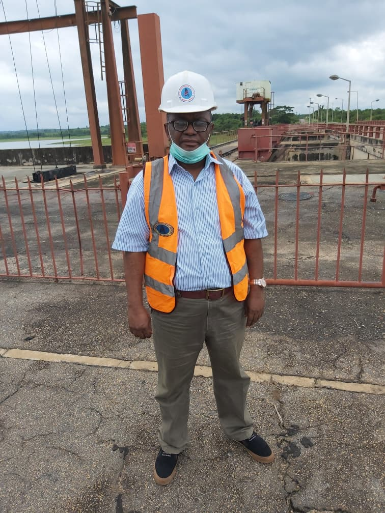 Engr. Ibe-Okosobo in hard hat and high-visibility vest on the spillway deck at Oyan Dam, Ogun State