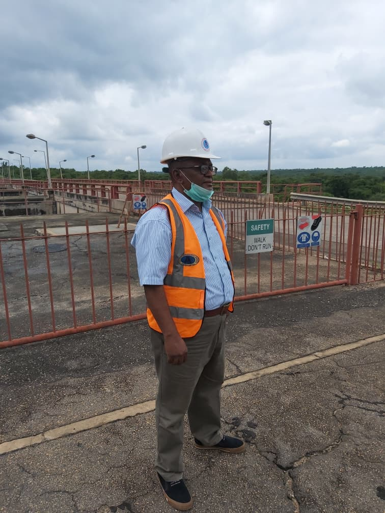 Engr. Ibe-Okosobo walking the Oyan Dam structure past site safety signage during project works