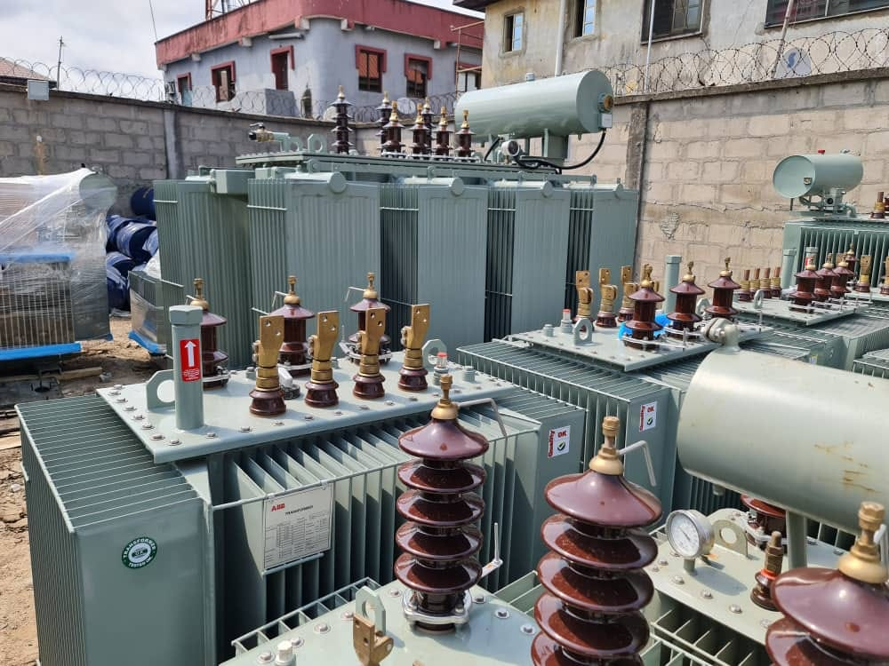 Close view of transformer HV bushings, LV brass palms, oil temperature gauge and quality-checked ABB rating plate